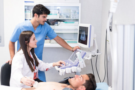 Medics examining patient with ultrasonic