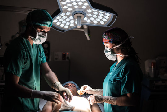 Surgeons doing operation in operating room