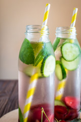 Detox water infused with fruits. Summer water fruit on rustic background
