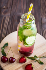 Detox water infused with fruits. Summer water fruit on rustic background