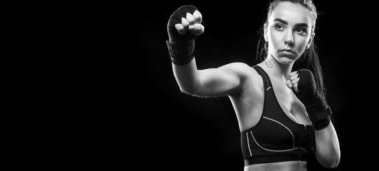 Sportsman muay thai boxer fighting. Isolated on black background. Copy Space.