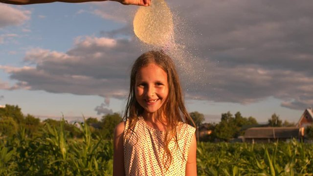 Water Balloon Splash on Little Girl's Head