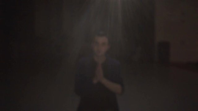 Young Man Praying, Pensive person Portrait Face Meditating in darkness