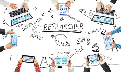 Top view of businesspeople sitting at table and using gadgets