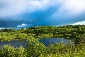 Obraz na płótnie Canvas Landscape with a small lake and stormy skies.