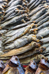 Dried salted fish lies on the counter for sale
