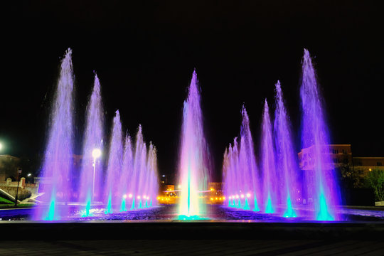 colored water fountain at night