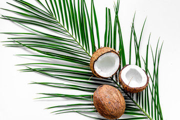 Fototapeta na wymiar Appetizing cocount and palm branch on white background top view