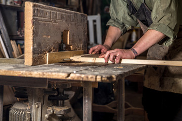 a man working with wood product on the machine