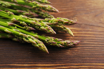 Fresh asparagus on a wooden surface.