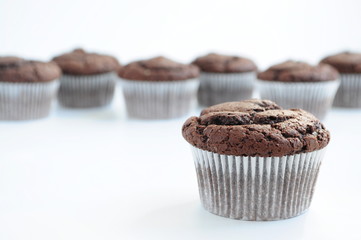 Chocolate muffins on white background. Picture for a menu or a confectionery catalog.