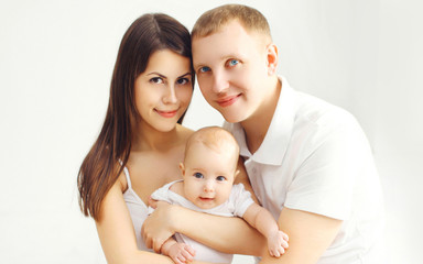 Portrait happy family mother and father with baby at home