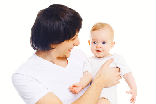 Portrait of happy young smiling father playing with baby on hands over white background