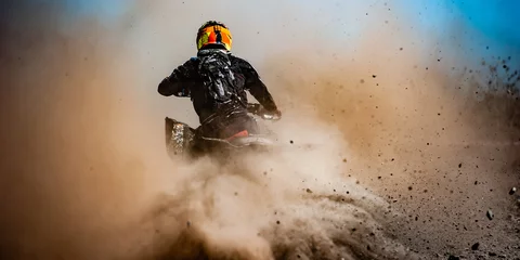 Foto op Canvas ATV rider creates a large cloud of dust and debris © KopoPhoto