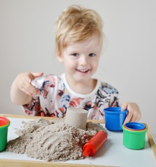 Little Girl Playing with Kinetic Sand at Home Early Education Preparing for School  Development 
