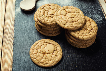 Biscuit sweet cookie background. Domestic stacked butter biscuit pattern concept,close up macro.Homemade cookies on wooden table.Cereal biscuits with the sesame,peanuts,sunflower and amaranth.