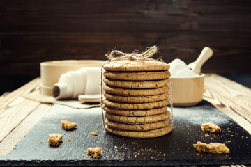 Biscuit sweet cookie background. Domestic stacked butter biscuit pattern concept,close up macro.Homemade cookies on wooden table.Cereal biscuits with the sesame,peanuts,sunflower and amaranth.