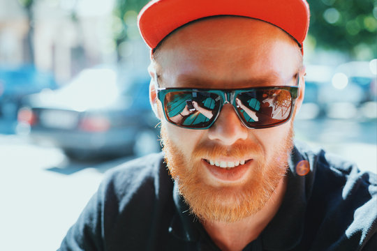 Beautiful man in sunglasses. Smartphone reflection