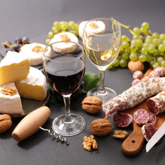 wine glasses with cheese and salami
