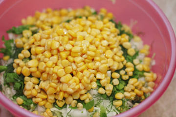 Fresh salad with canned corn, cabbage and parsle