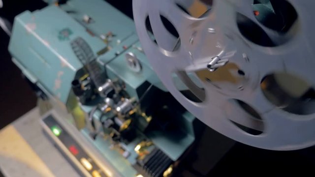 Film tape going through film projector.