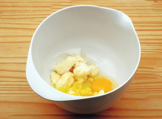 Bowl with margarine and eggs for the preparation of Plum Cake
