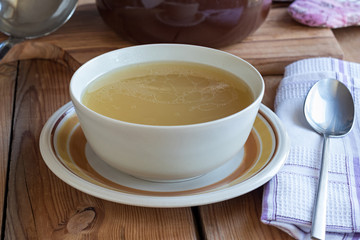 Bone broth made from chicken served in a soup bowl