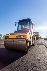 Work on asphalt paving on a sunny day	 