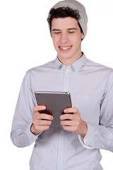 Fototapeta na wymiar Portrait of young man using tablet.