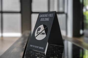 No smoking sign on a shelf of hotel room. Concept photo of banning smoking in public area, medical,...