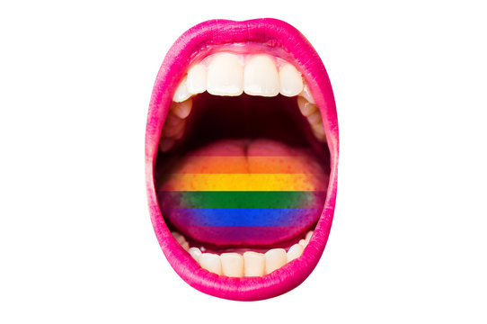 Flag of LGBT in woman's mouth, on tongue, sexy concept of rainbow flag. Female lips with lipstick, white teeth, rainbow in tongue of girl. Woman screams at rally pride about rights of minorities