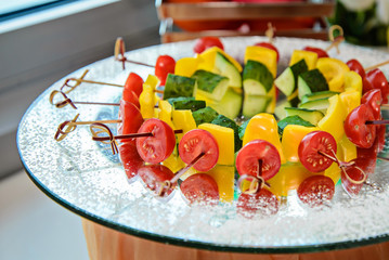 Colorful vegetables on the skewers in the dish