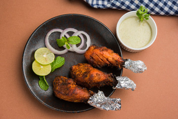 Chicken Tangri kabab or kebab - three Chicken leg pieces marinated with red sauce then grilled and...