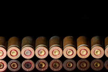 Lined in a straight row of empty shells of 9 mm pistol close up