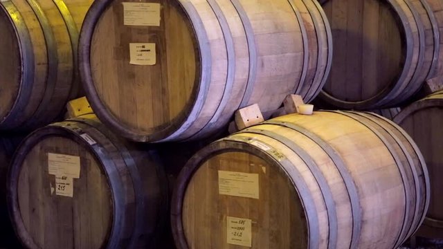 Wine barrels stacked in the cellar of the winery