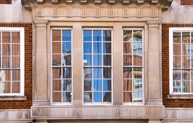 Fototapeta na wymiar Windows of the luxury apartments in Mayfair. Centre London residential buildings. 
