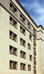 Part of the wall with windows of a modern house on a summer day. View at an angle to the building