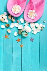 Pink flip flops and seashells