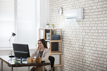 Businesswoman Working In Office With Air Conditioning