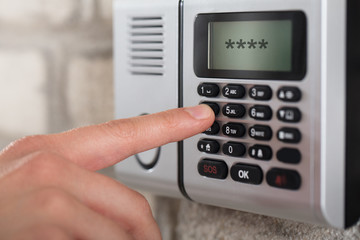 Human Hand Entering Security System Code