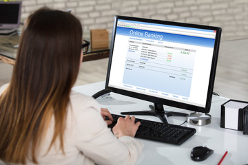 Businesswoman Doing Online Banking In Office