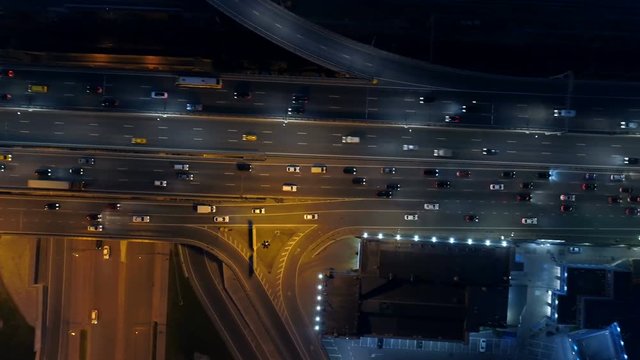 Cars on a highway at night. City roads and crossroads from above. 4K.
