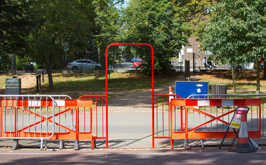 Red barrier and gate blocking the restricted aria in park, London  