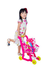 Asian Chinese little girl wearing cheongsam pushing toy trolley