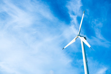 Fototapeta premium Wind turbines generating electricity with blue sky background.