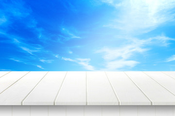 white wood table and blue sky background.