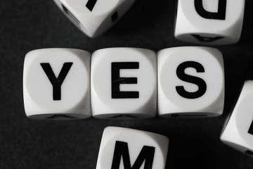 word yes on toy cubes