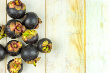 Mangosteen fruit on wooden table background.