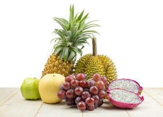 Set of different fruits on wooden table on white background.