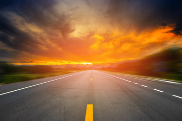 landscape of sunset or sunrise light above asphalt road